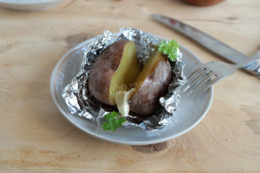 Baked potatoes in a slow cooker in foil in a uniform