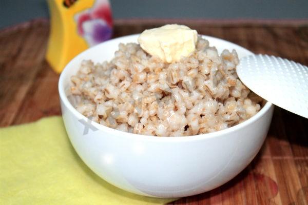 Pearl barley porridge on water with butter in a slow cooker