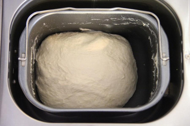 Yeast dough for bread in a bread maker with powdered milk