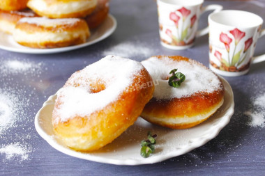 Homemade doughnuts in a pan with yeast