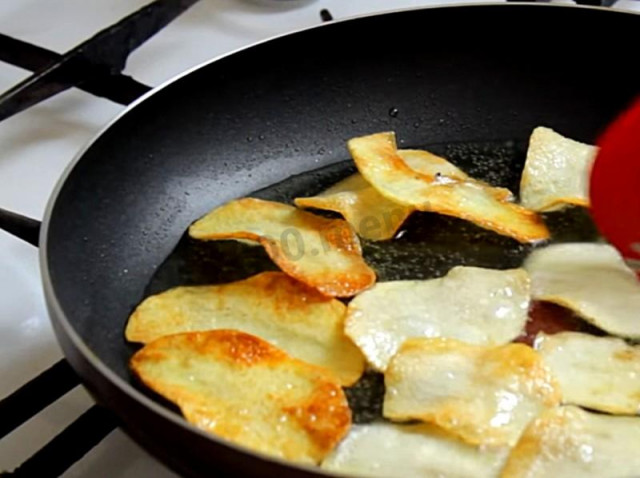 Homemade potato chips in a frying pan