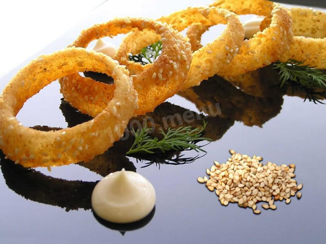 Onion fries in breaded rings with sesame seeds