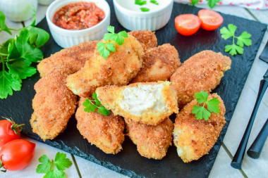 Crispy breaded chicken wings in a frying pan
