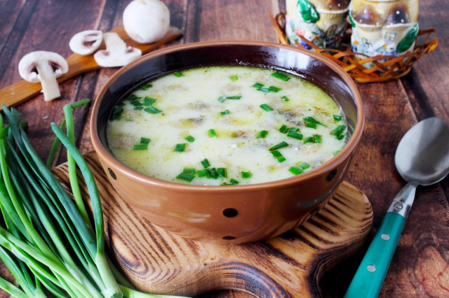 Creamy soup with mushrooms and melted cheese