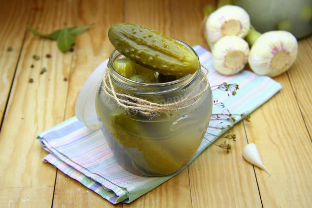 Pickled cucumbers under a nylon lid for winter
