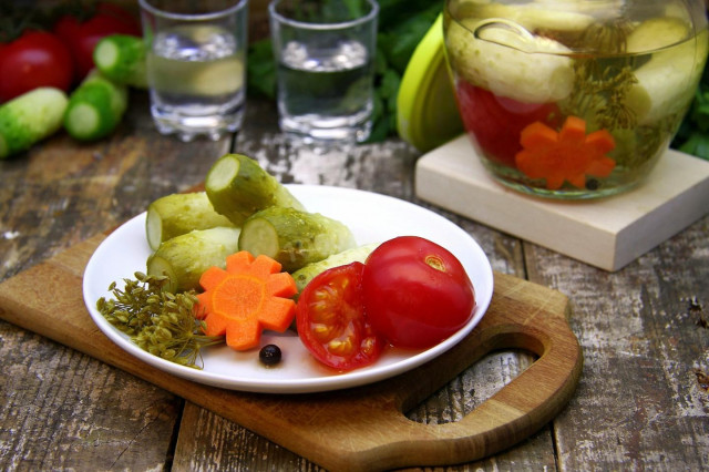 Pickled cucumbers with tomatoes for winter. Assorted vegetables