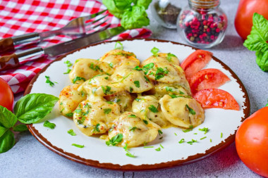 Fried dumplings with cheese in a frying pan