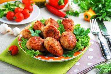 Chicken cutlets with mushrooms and cheese on frying pan