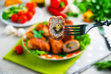 Chicken cutlets with mushrooms and cheese on frying pan