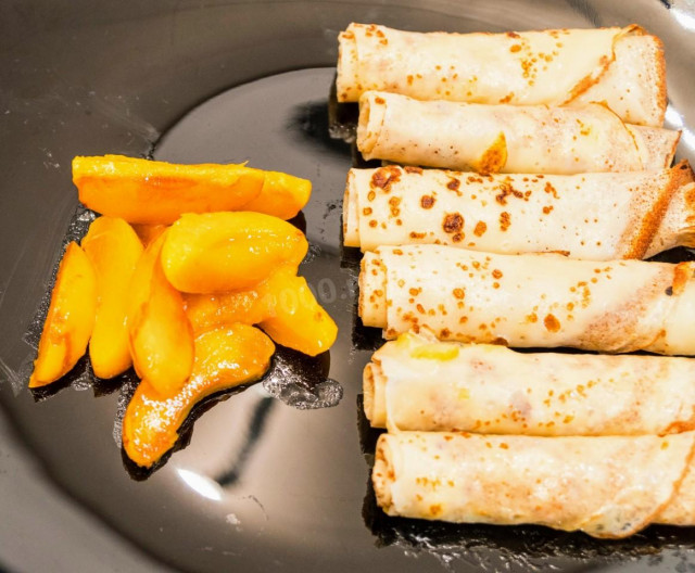 Fruit pancakes with milk with apricot filling