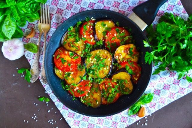 Fried eggplant slices in a pan with garlic