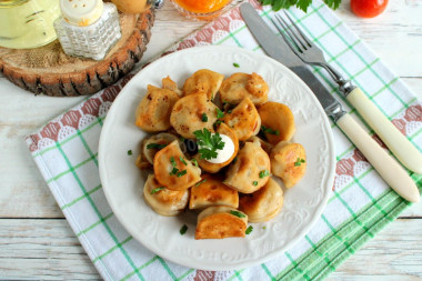 Frozen dumplings fried in a frying pan