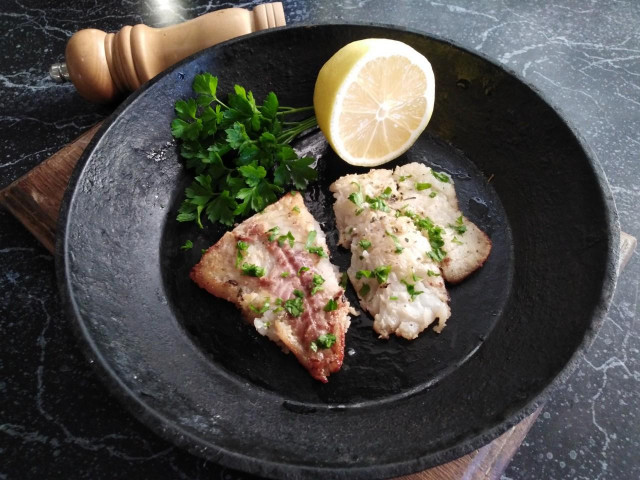 Hake fillet in a frying pan