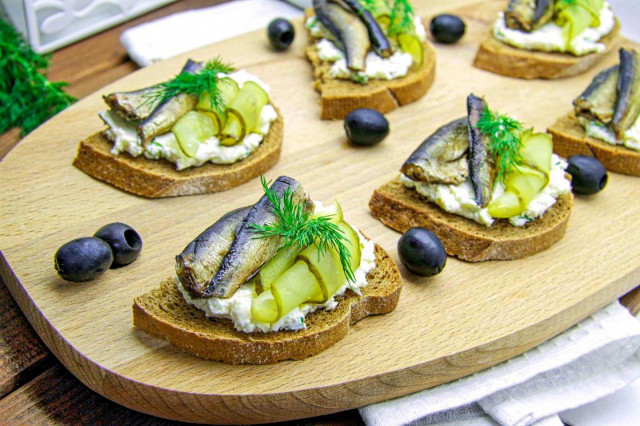 Sandwiches with sprats on black bread