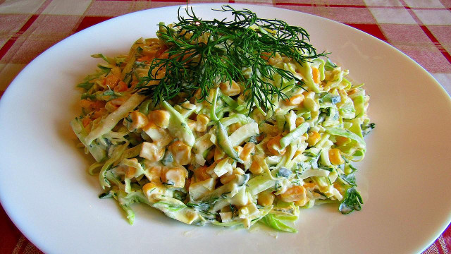 Young cabbage salad with corn and cucumbers