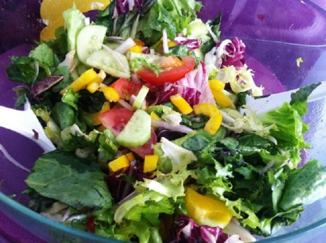 Vegetable salad lettuce leaves, yellow pepper, cucumbers, tomatoes