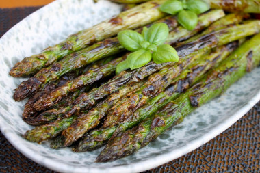 Green asparagus on charcoal on the grill