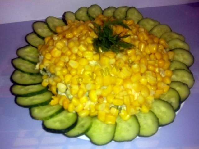 Salad with krill meat and cucumbers and corn and hard cheese