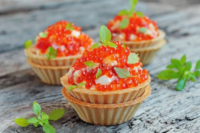Classic royal salad with red caviar in tartlets