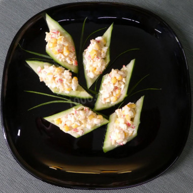 Salad crab sticks rice corn in cucumber boats