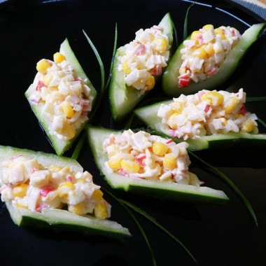 Salad crab sticks rice corn in cucumber boats