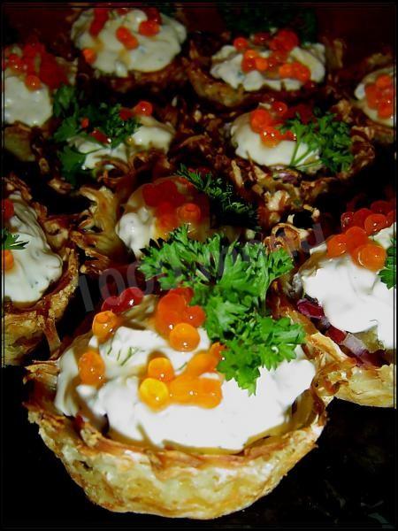 Potato tartlets with herring and caviar