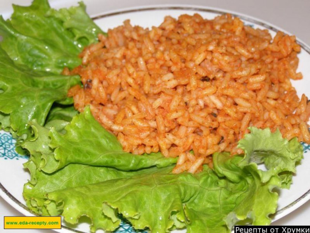 Rice with tomato paste, garlic and basil to garnish
