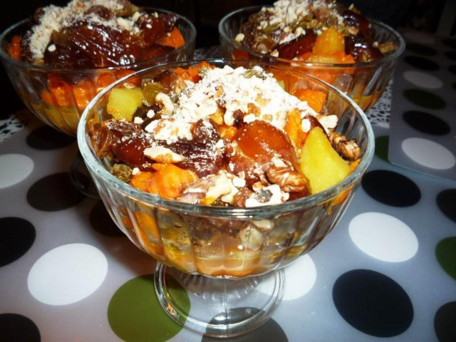 Pumpkin dessert with raisins and dried fruits in a frying pan