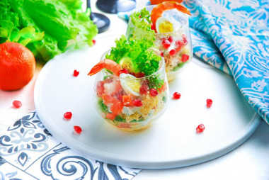 Salad in cream bowls with shrimp, portioned festive