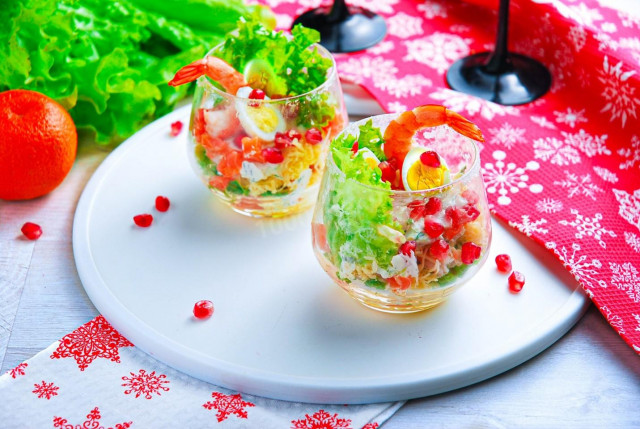 Salad in cream bowls with shrimp, portioned festive