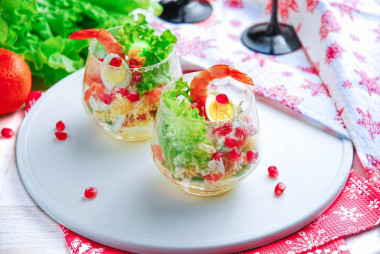 Salad in cream bowls with shrimp, portioned festive