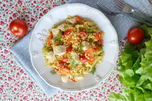 Bulgur with chicken and vegetables in a frying pan