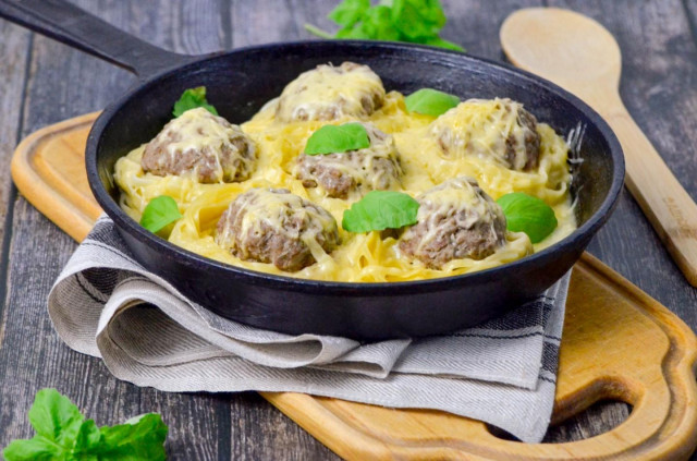 Nests of pasta with minced meat and cheese in a frying pan