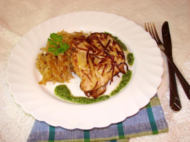 Chicken fillet in potatoes with side dish and sauce