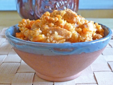 Porridge with meat in a pot in the oven pearl barley