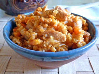 Porridge with meat in a pot in the oven pearl barley