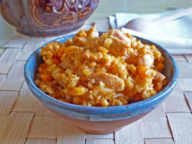 Porridge with meat in a pot in the oven pearl barley