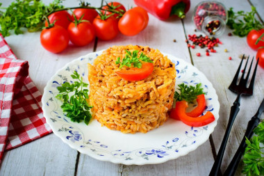 Rice with minced meat and tomato paste in a frying pan