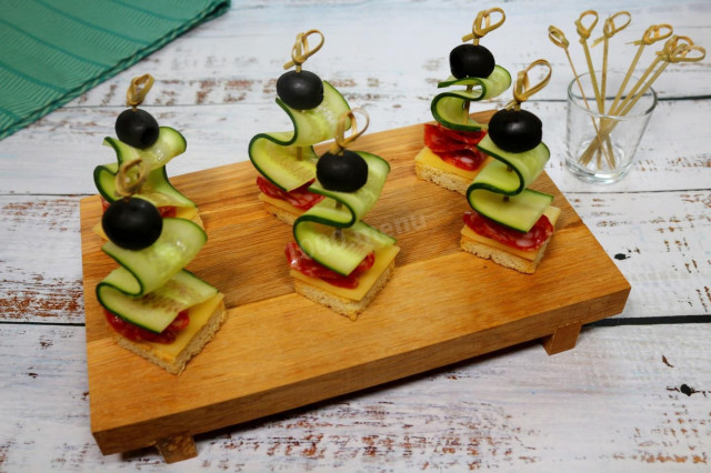 Canapes with sausage and cheese on skewers