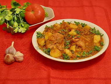 Chicken Chakhokhbili with potatoes in a frying pan