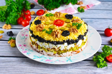 Salad with prunes and chicken layers