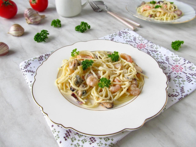 Pasta with a sea cocktail in cream sauce