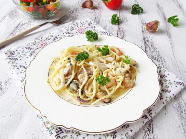 Pasta with a sea cocktail in cream sauce