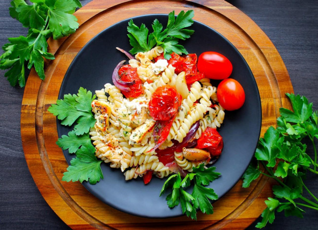 Pasta with vegetables and cheese in the oven