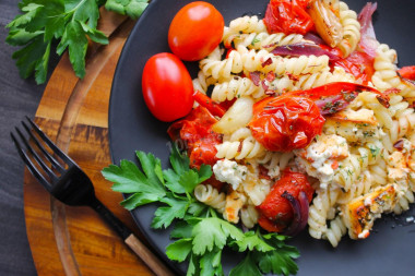 Pasta with vegetables and cheese in the oven