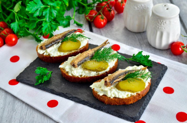 Sandwiches with sprats, eggs and pickled cucumber