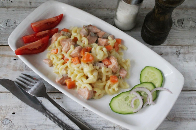 Pasta with pink salmon, onion and carrot in sauce