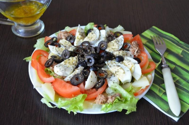 Nicoise fish salad with black olives and chicken eggs