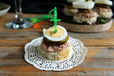 Canapes with canned tuna and pickled cucumbers