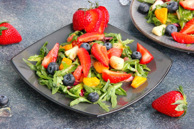 Fruit salad dessert with mango and strawberries